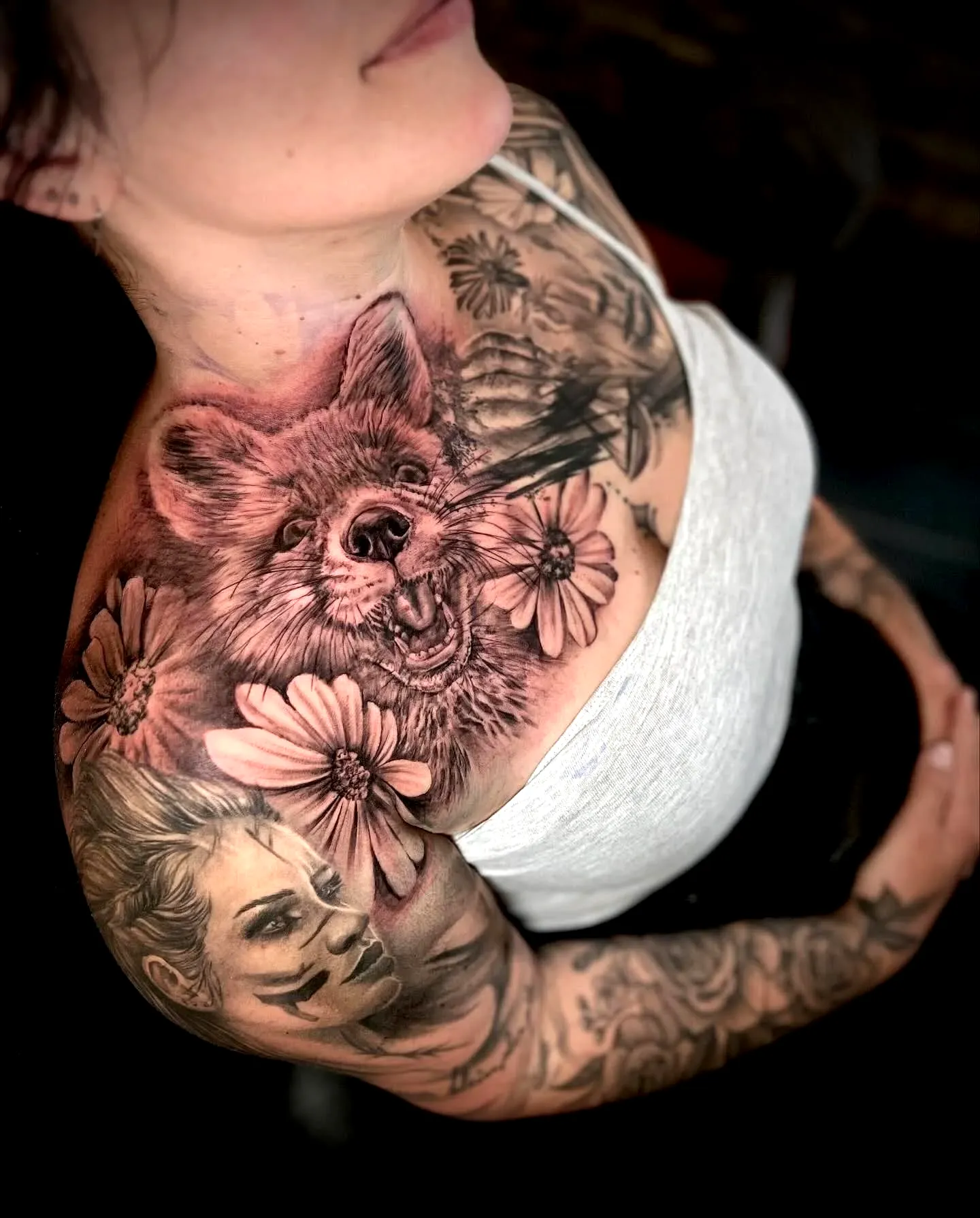 Shoulder tattoo for women featuring realistic fox and floral elements