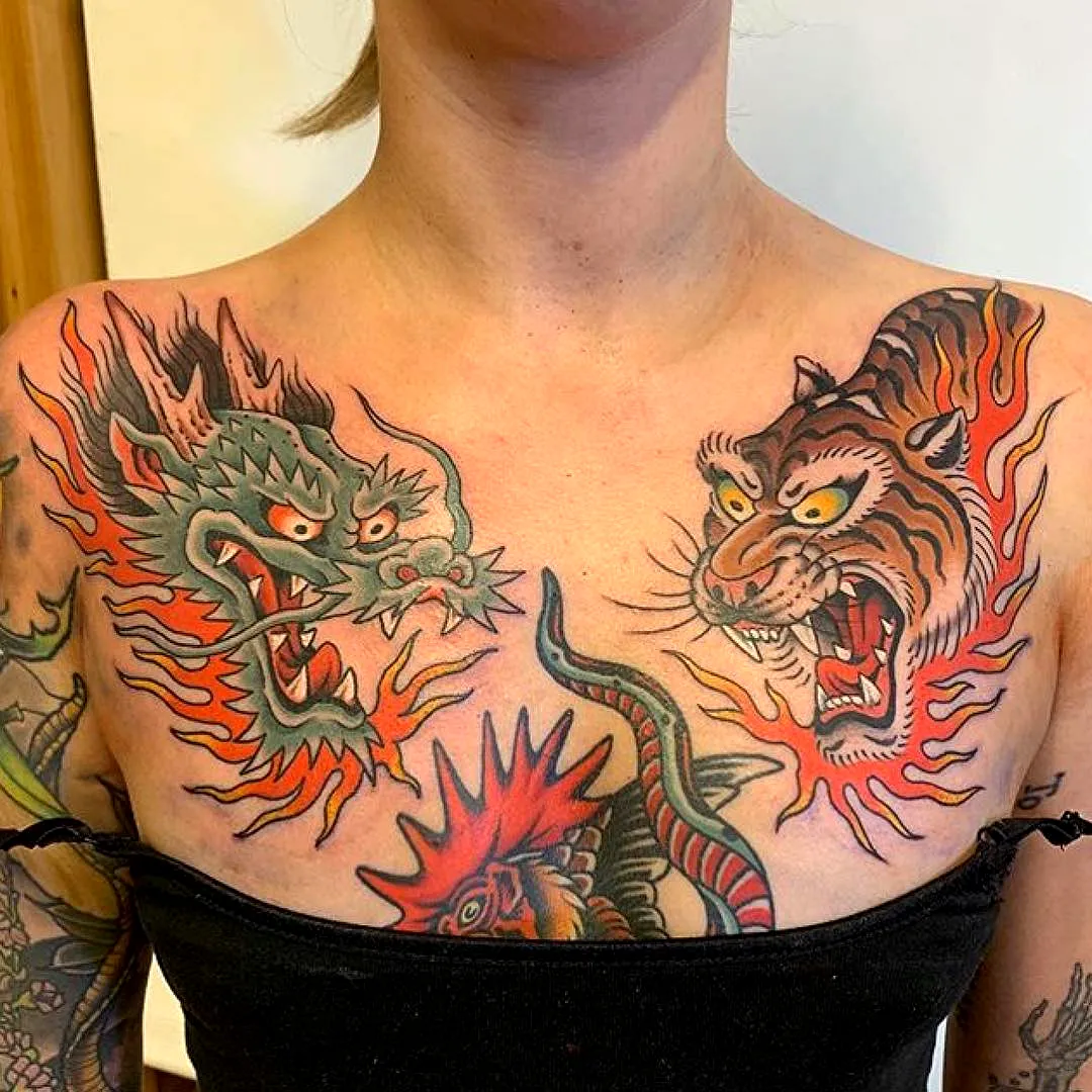 Vibrant dragon and tiger chest tattoo with flames