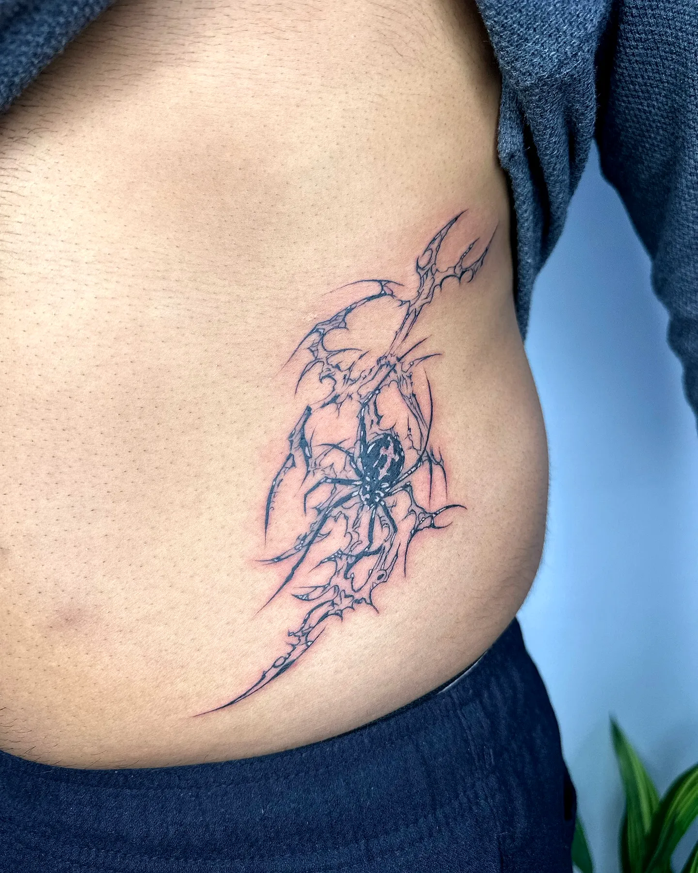Abstract Spider Rib Tattoo in Black Ink