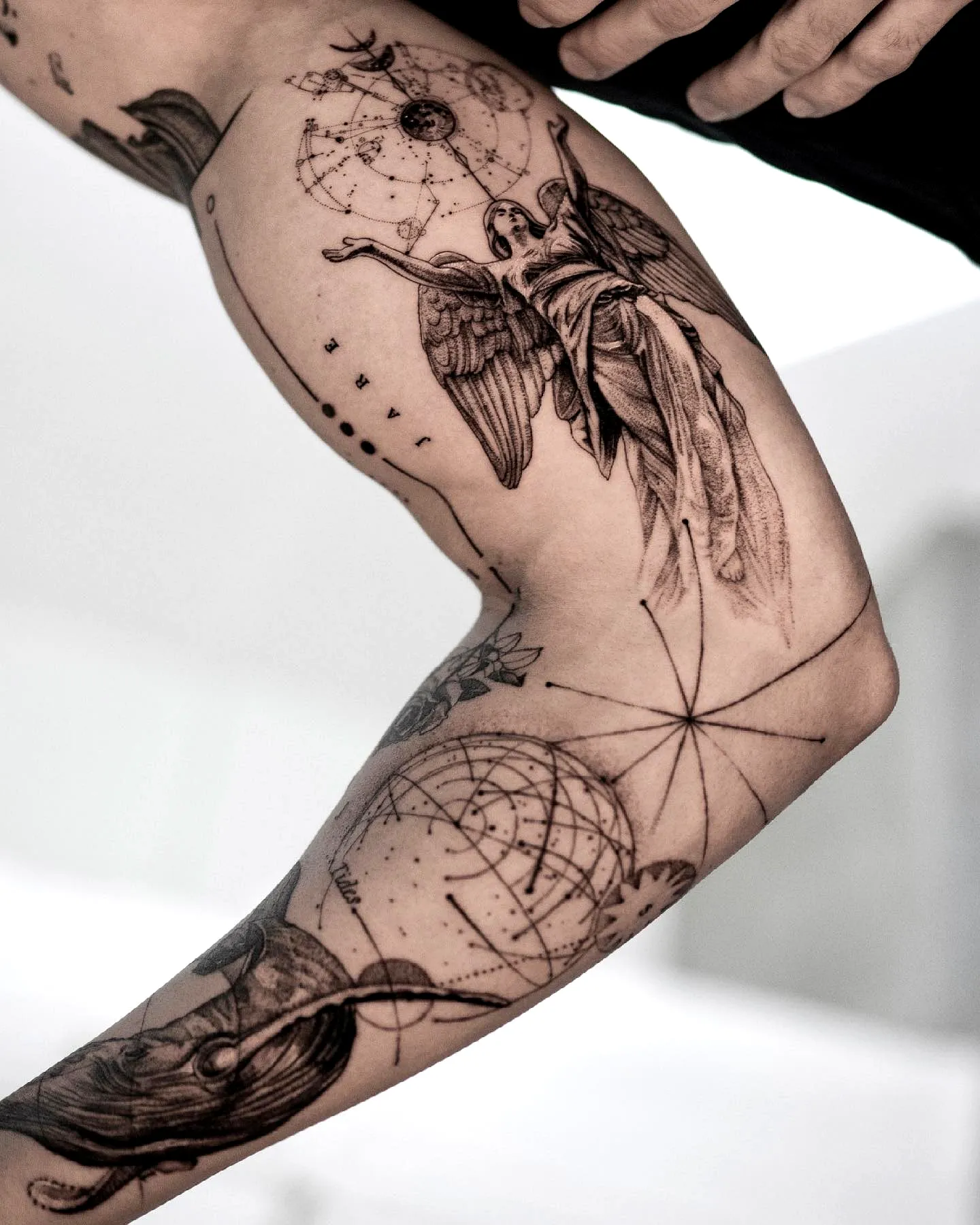 Angel arm tattoo with celestial elements