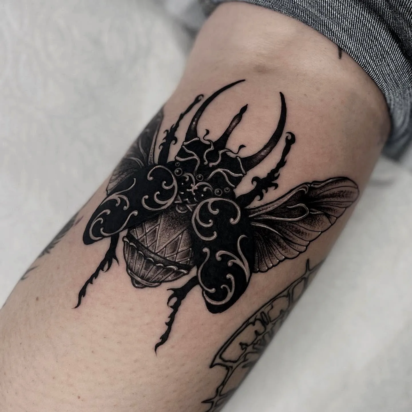 Beetle Forearm Tattoo with Intricate Patterns