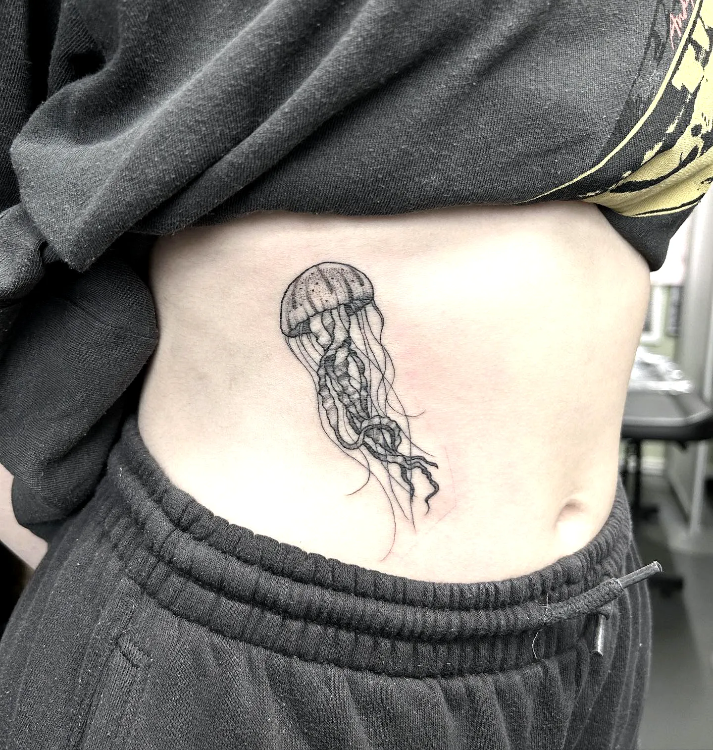 Black Ink Jellyfish Rib Tattoo