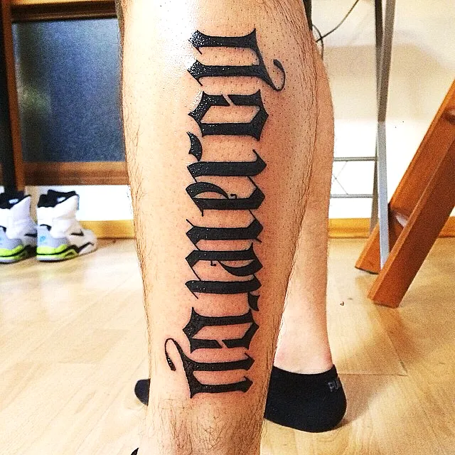 Bold Black Lettering Calf Tattoo