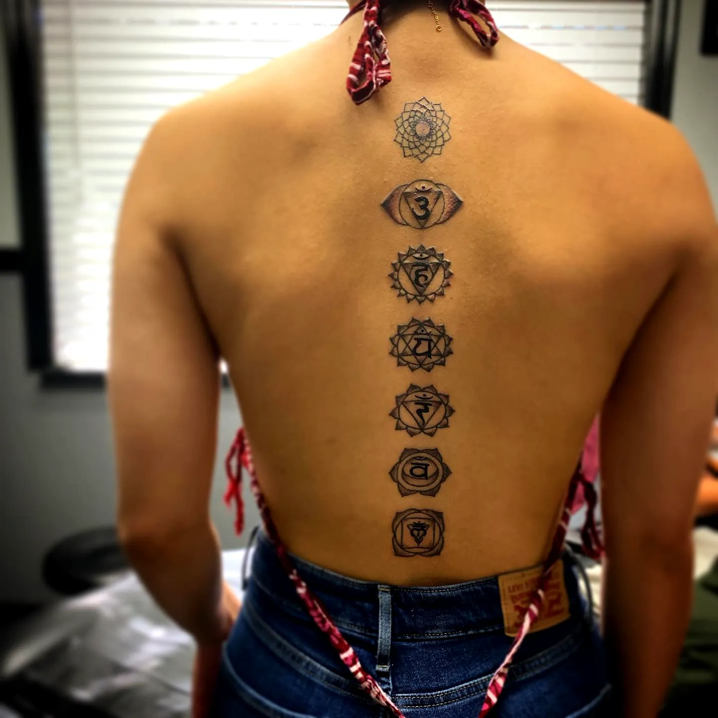 Chakra Spine Tattoo with Geometric Patterns