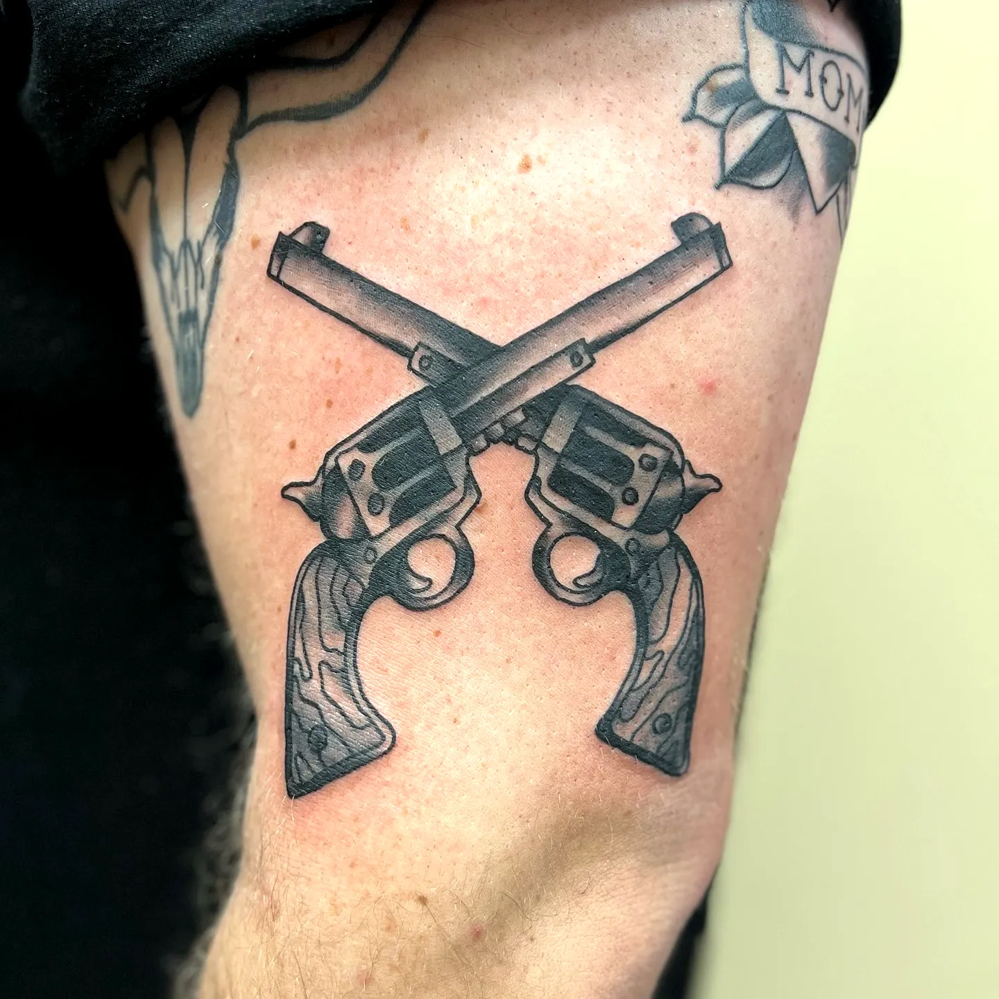 Crossed Revolvers Arm Tattoo