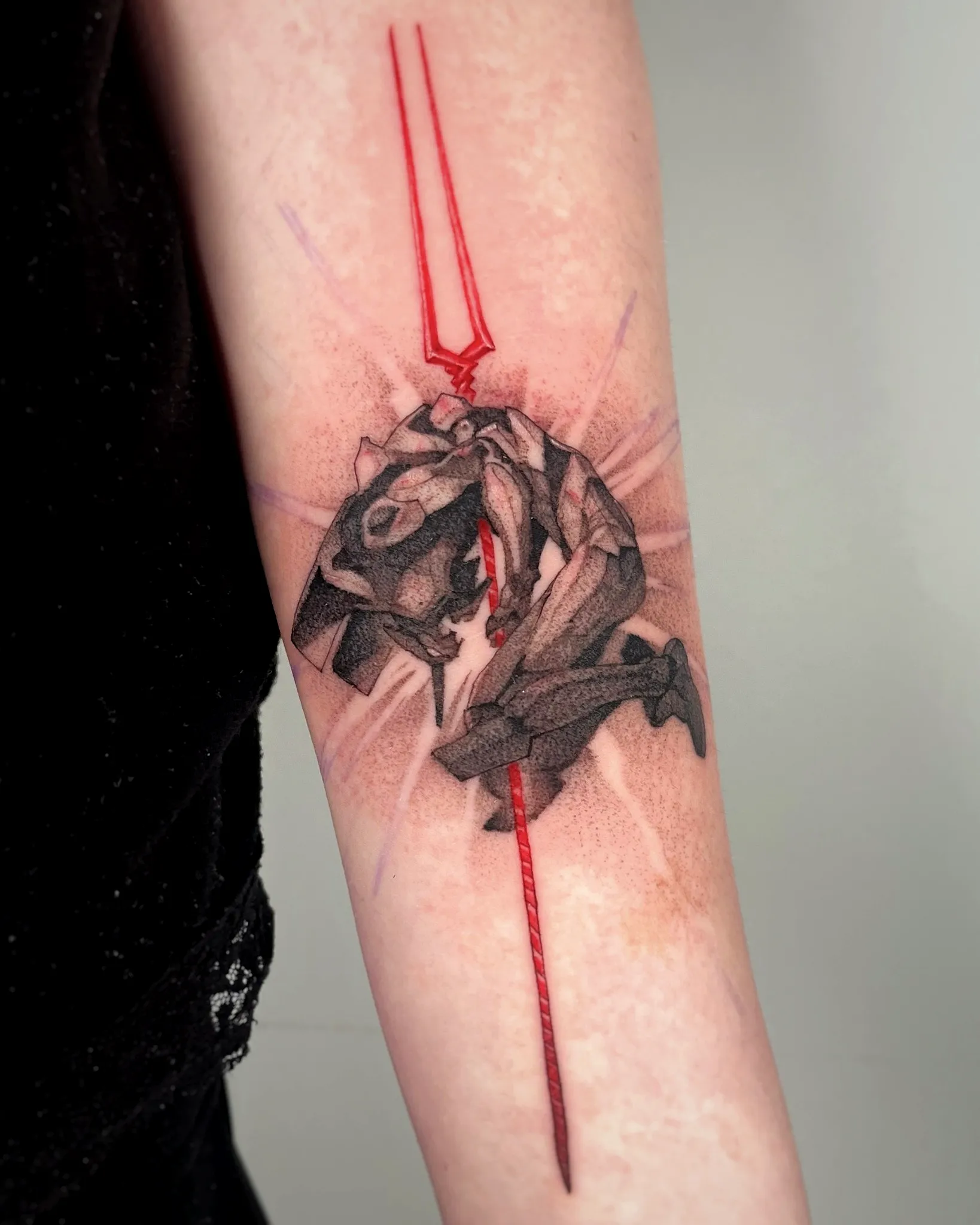 Crouched Figure Arm Tattoo with Red Spear