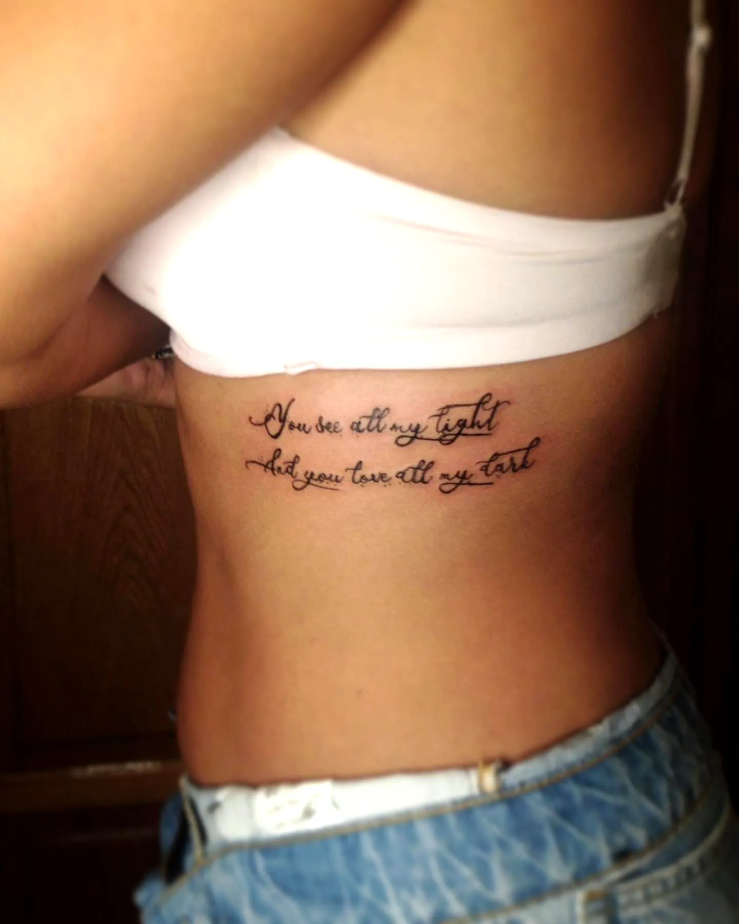 Cursive Rib Tattoo in Black Ink