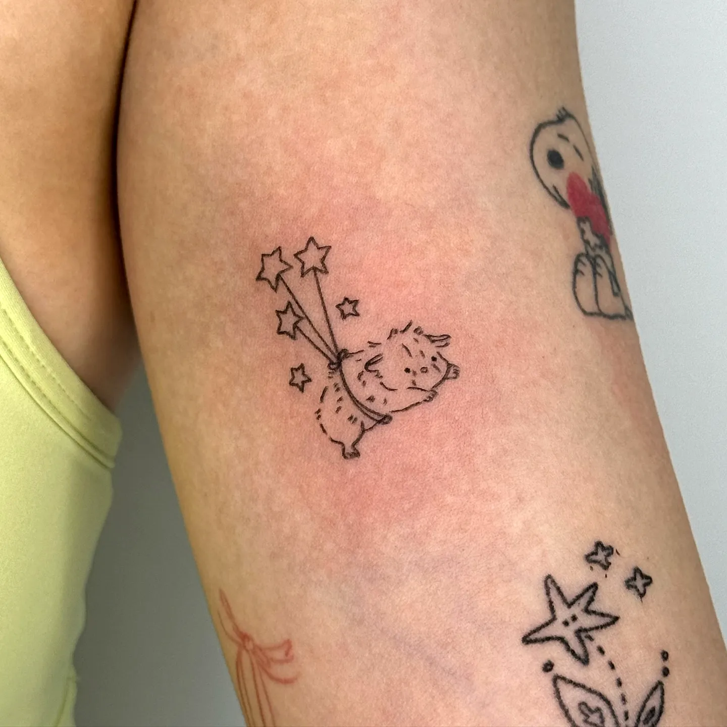 Cute Creature Upper Arm Tattoo