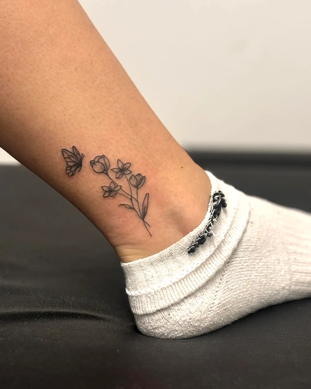 Dainty Flower Ankle Tattoo with Butterfly