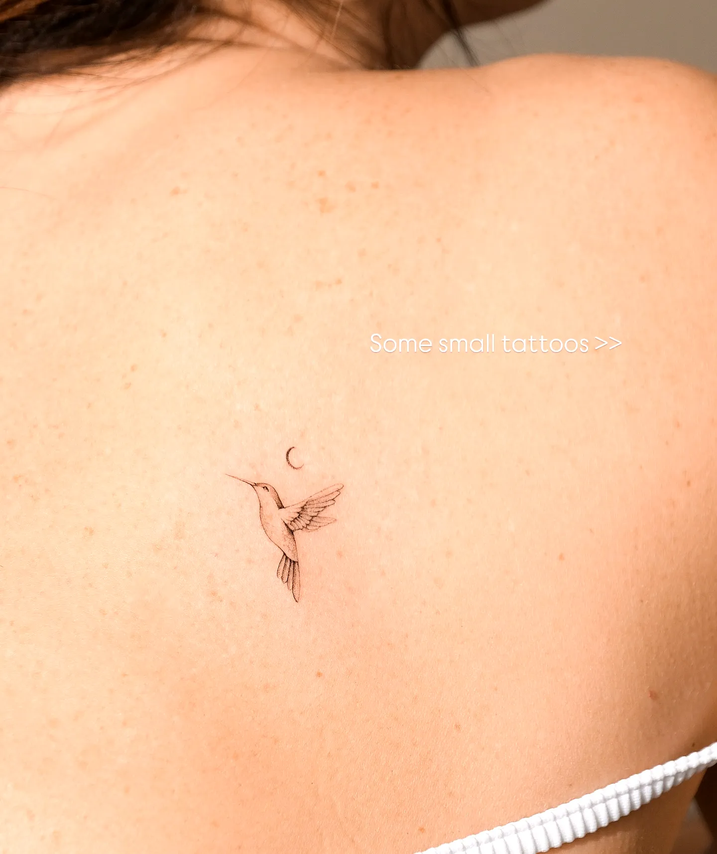 Dainty Hummingbird Upper Back Tattoo