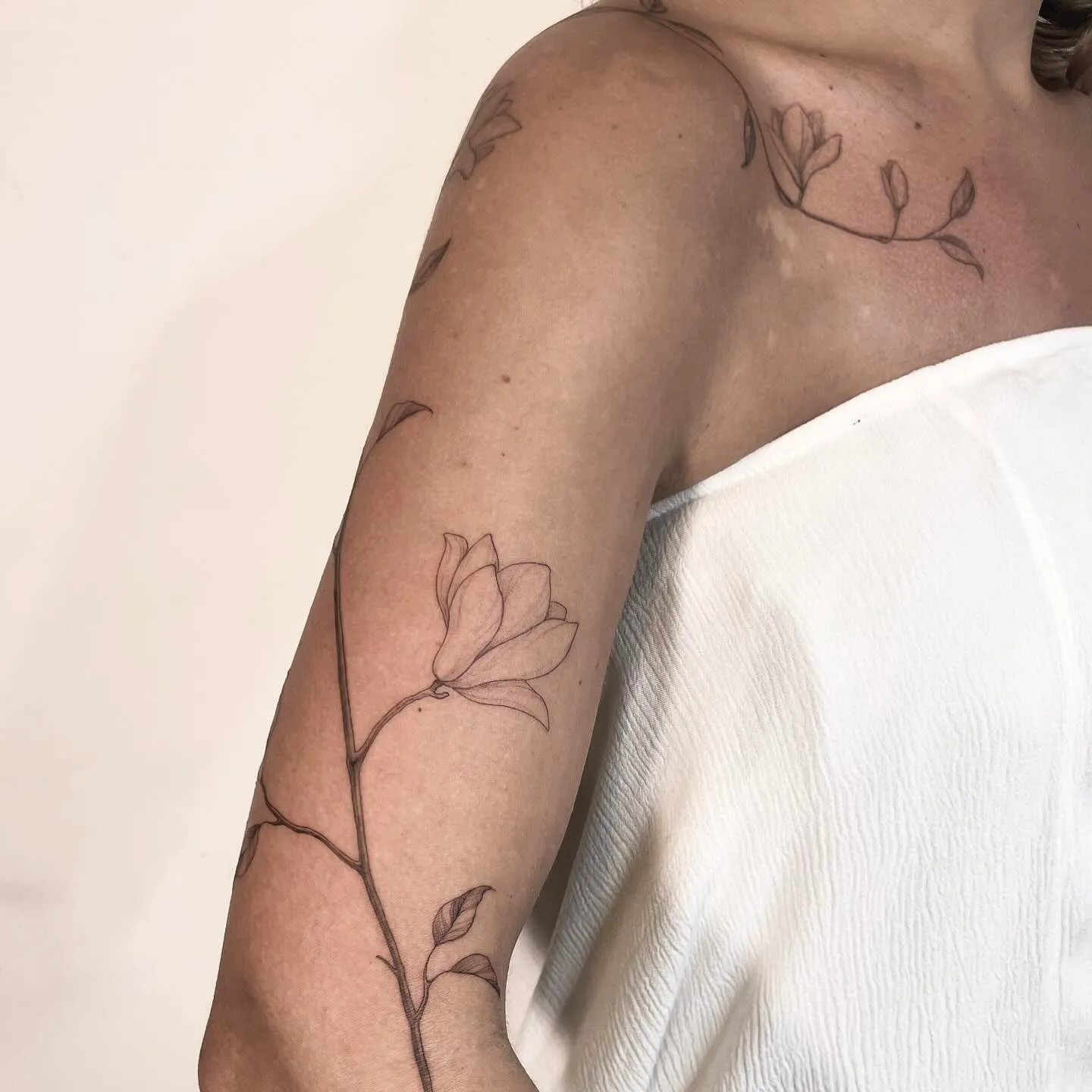 Dainty Magnolia Arm Tattoo