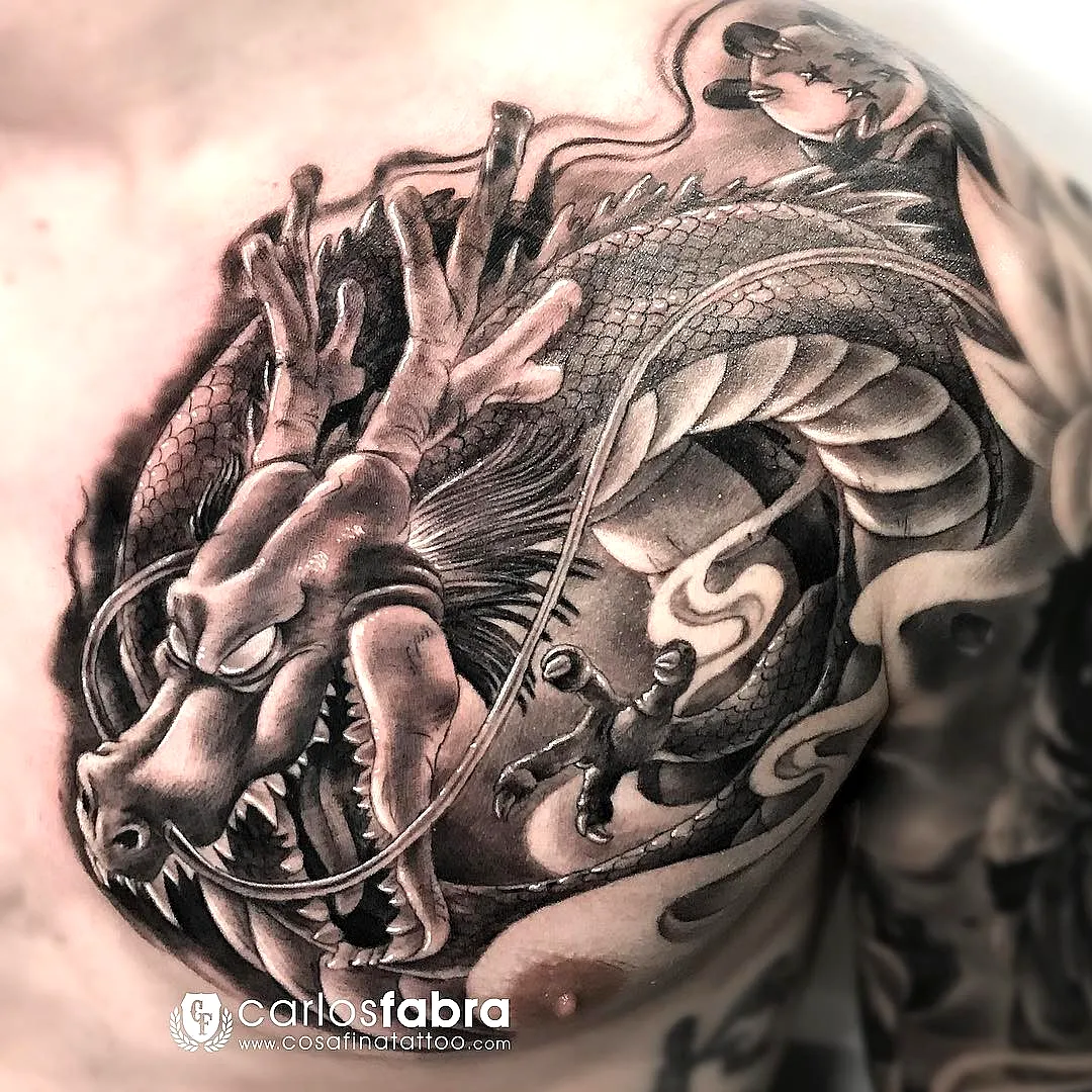 detailed black and gray dragon chest tattoo