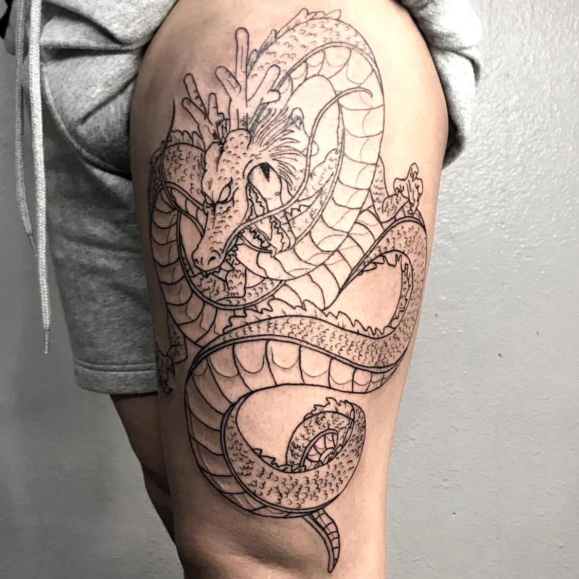 Dragon Thigh Tattoo in Black Ink
