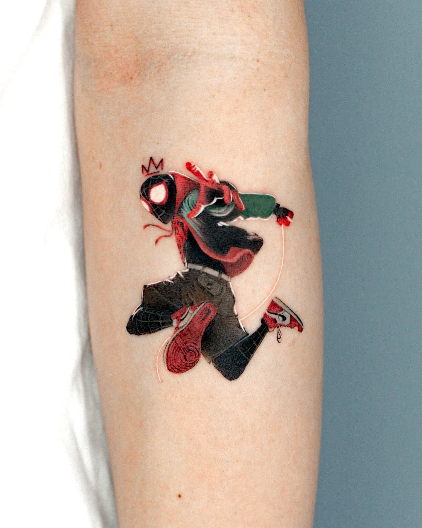 Dynamic Superhero Forearm Tattoo