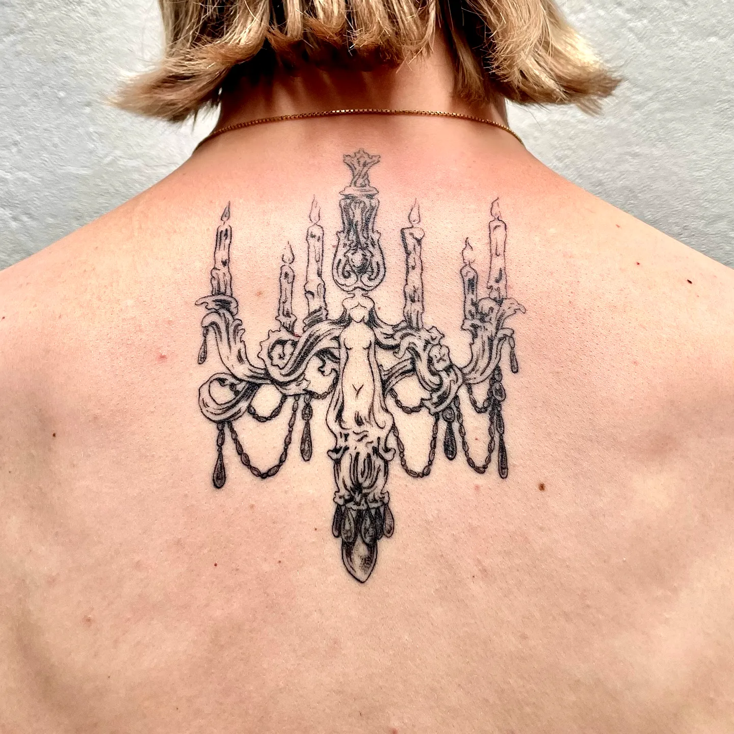 Elegant Chandelier Upper Back Tattoo