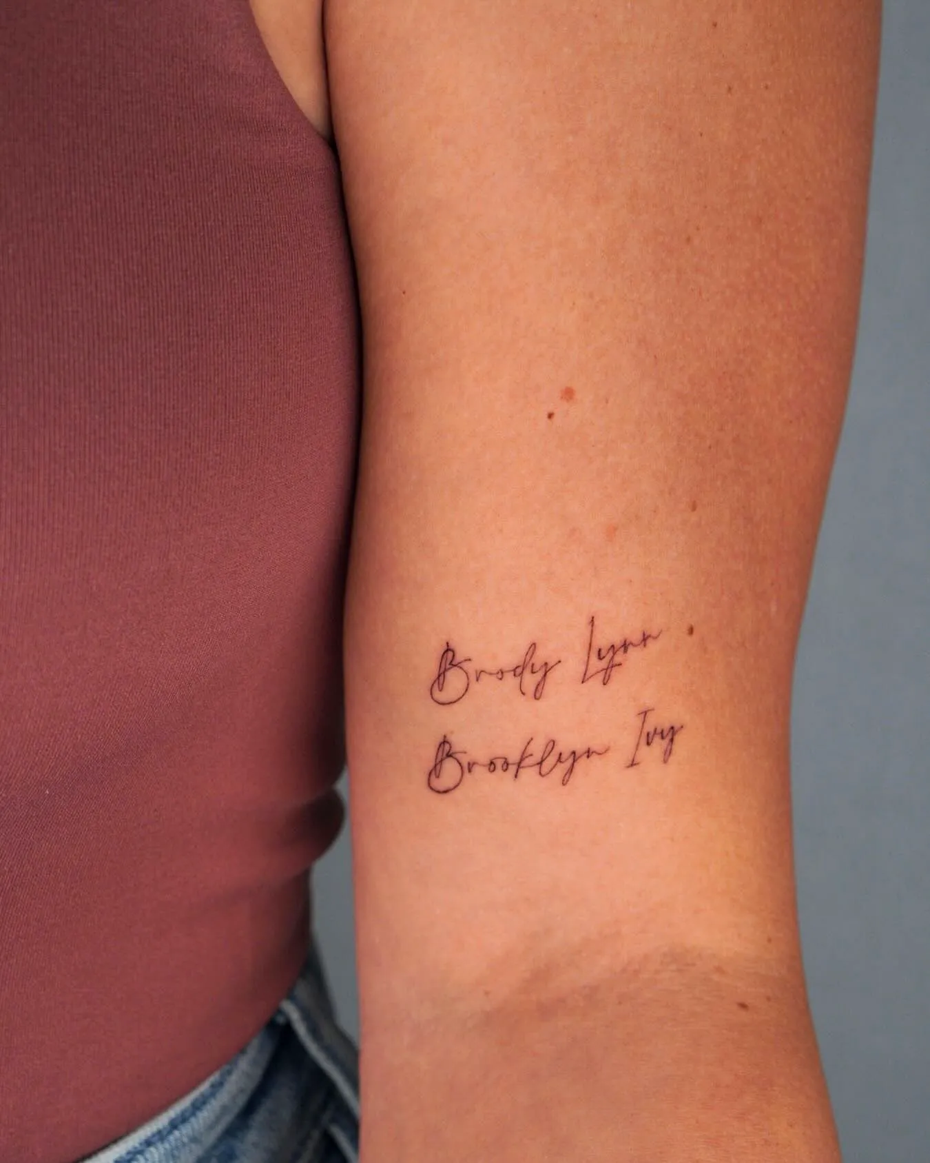 Elegant Inner Arm Mom Tattoo in Dark Ink