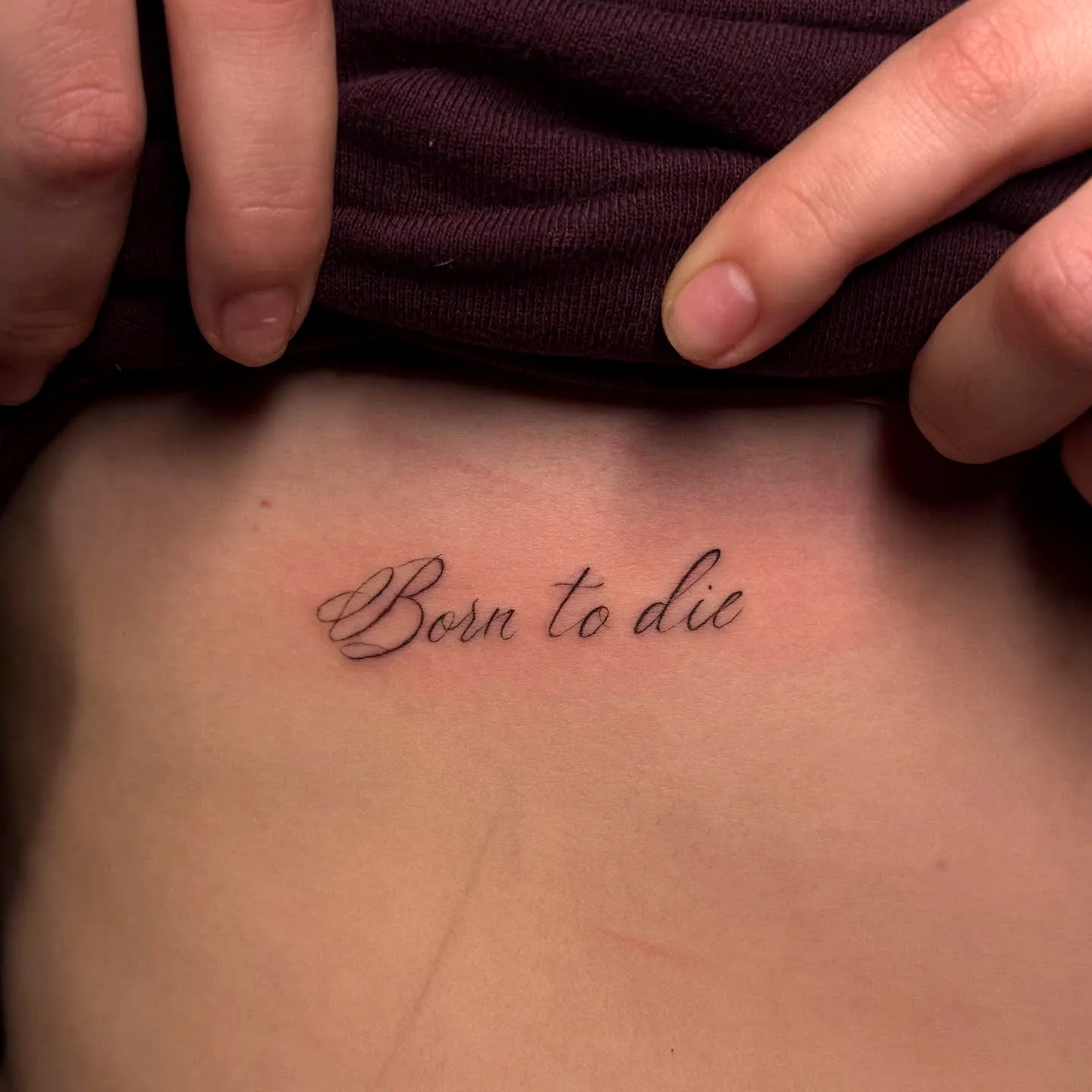Elegant Script Lower Back Tattoo