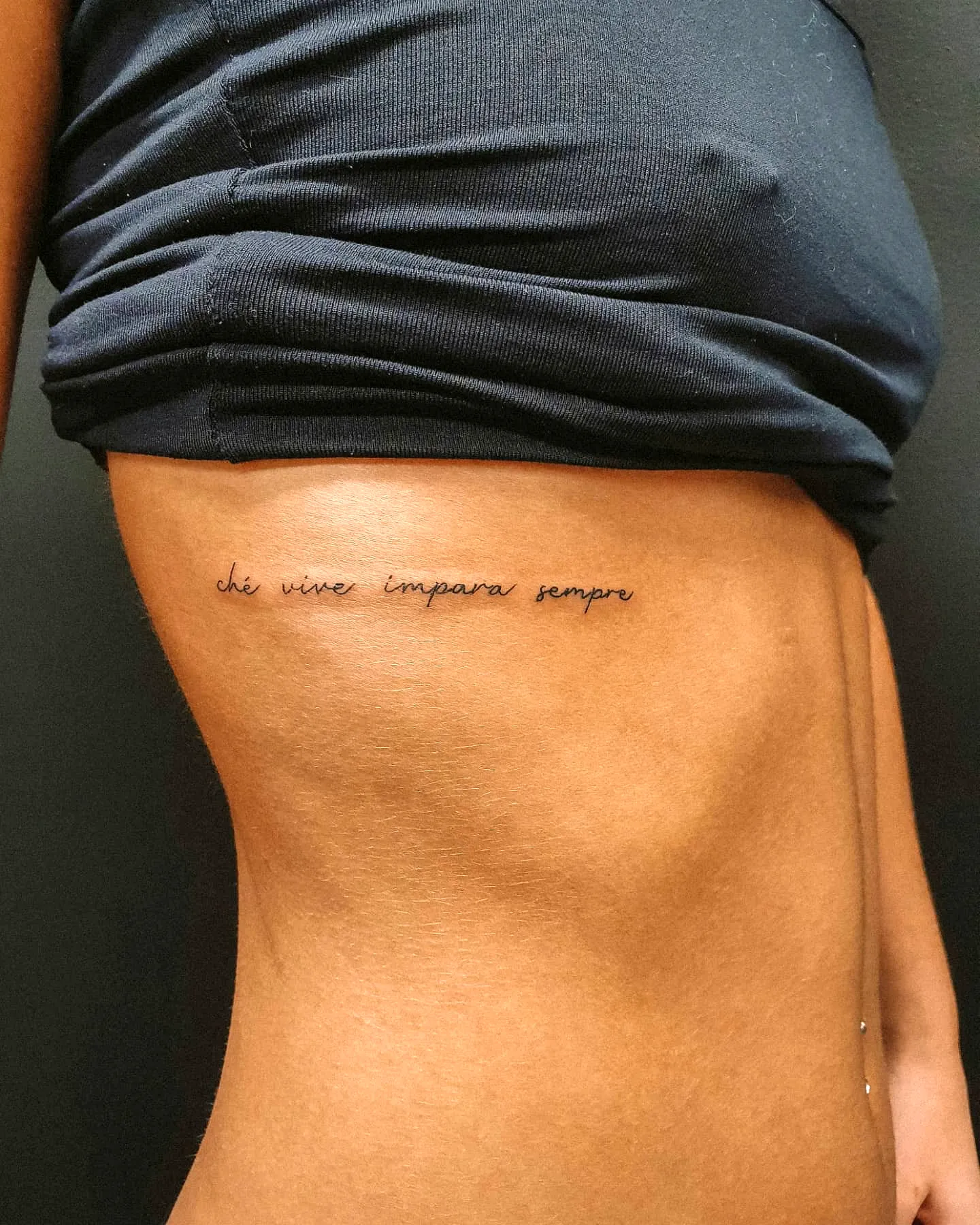 Elegant Script Rib Tattoo in Black