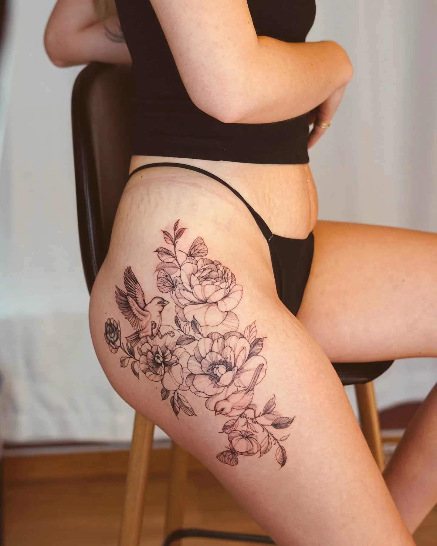 Floral Bird Thigh Tattoo in Black Ink