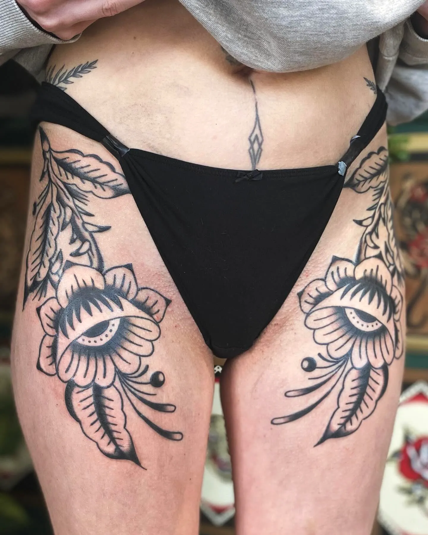 Floral Eye Thigh Tattoo in Black Ink