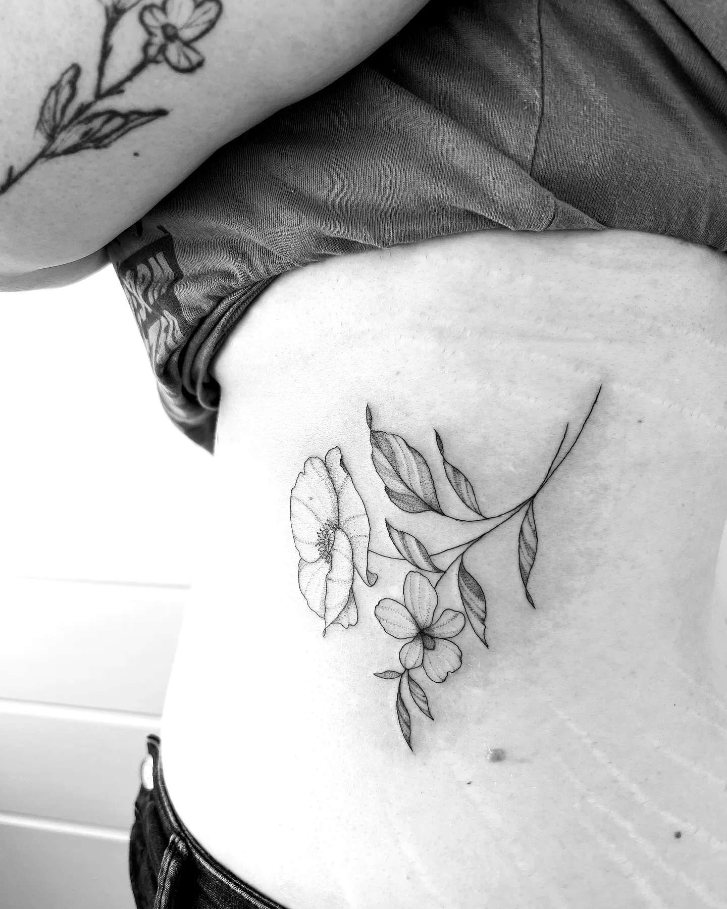 Floral Rib Tattoo in Black Linework