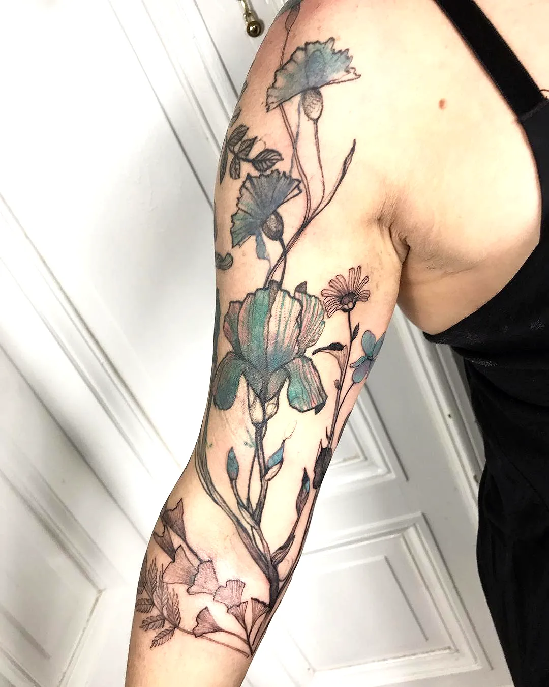 Floral Upper Arm Tattoo in Black and Teal