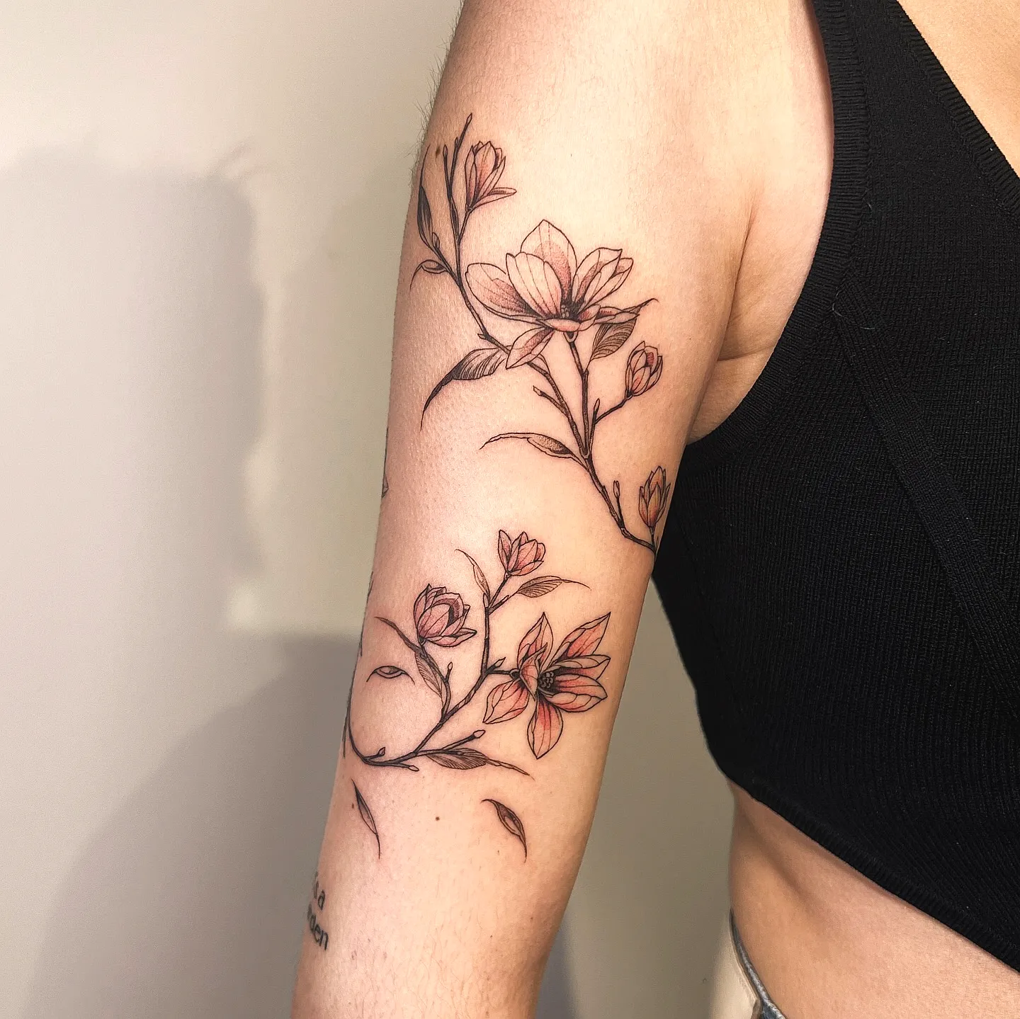 Floral Upper Arm Tattoo with Pink Blooms