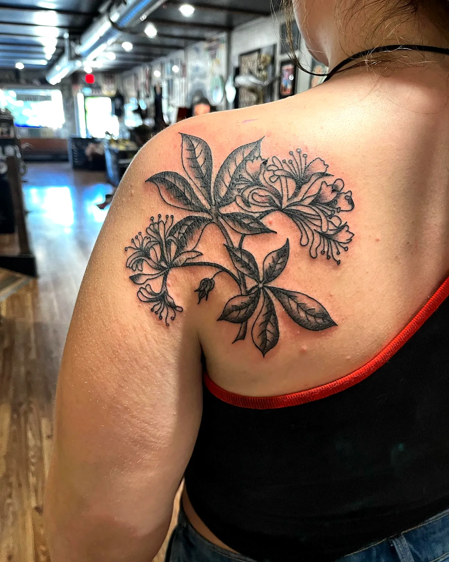 Floral Upper Back Tattoo in Black Ink