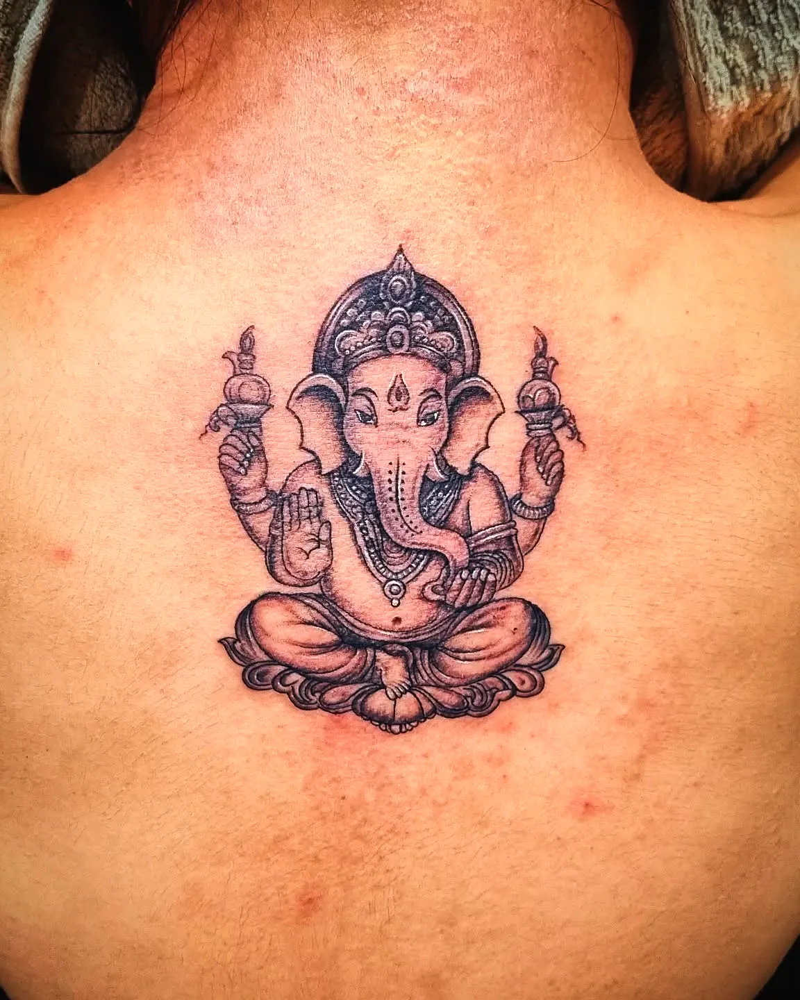 Ganesha Black Ink Upper Back Tattoo