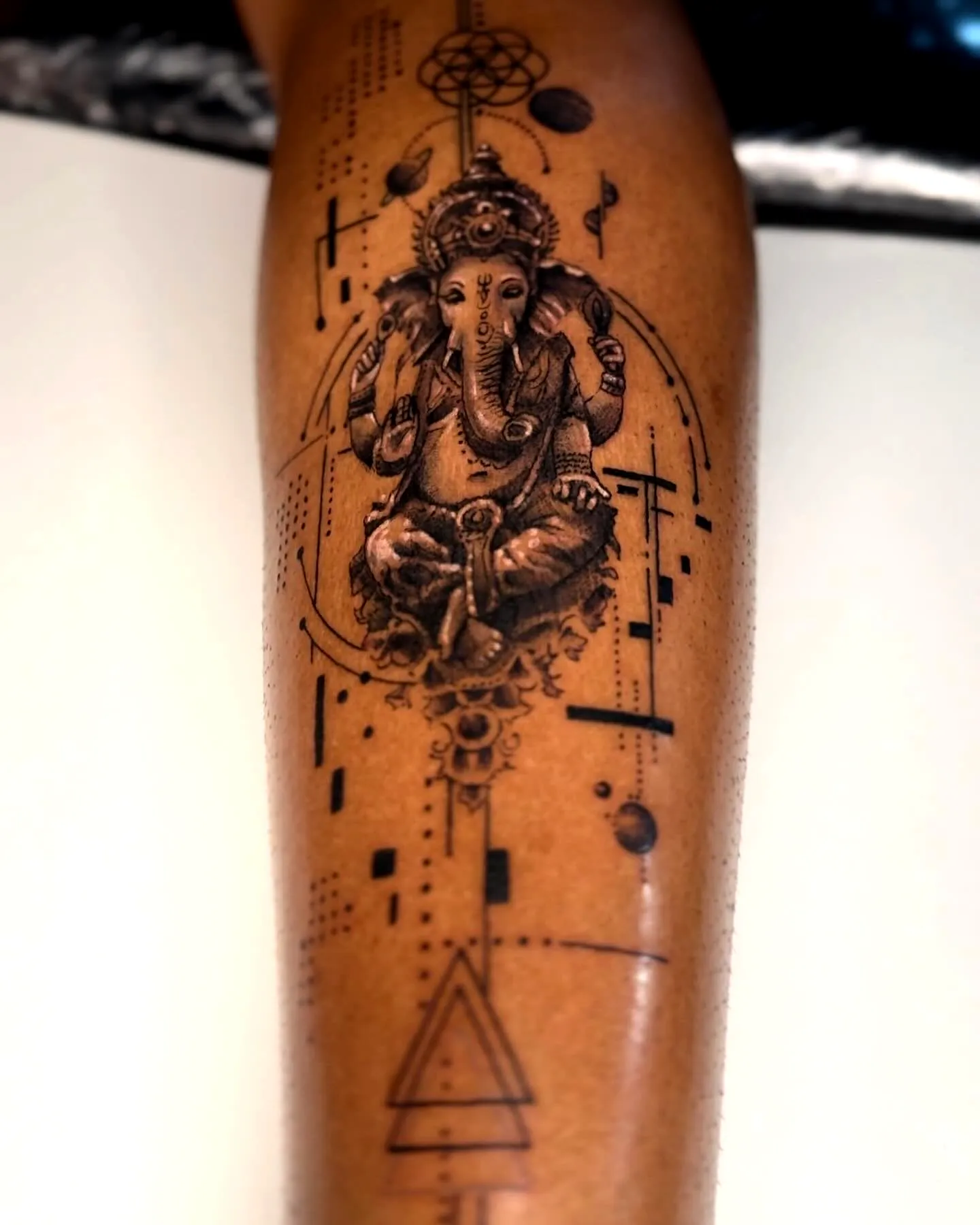 Ganesha Forearm Tattoo with Geometric Patterns