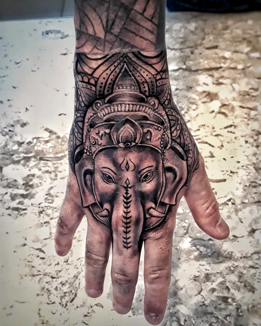 Ganesha Hand Tattoo with Ornate Patterns