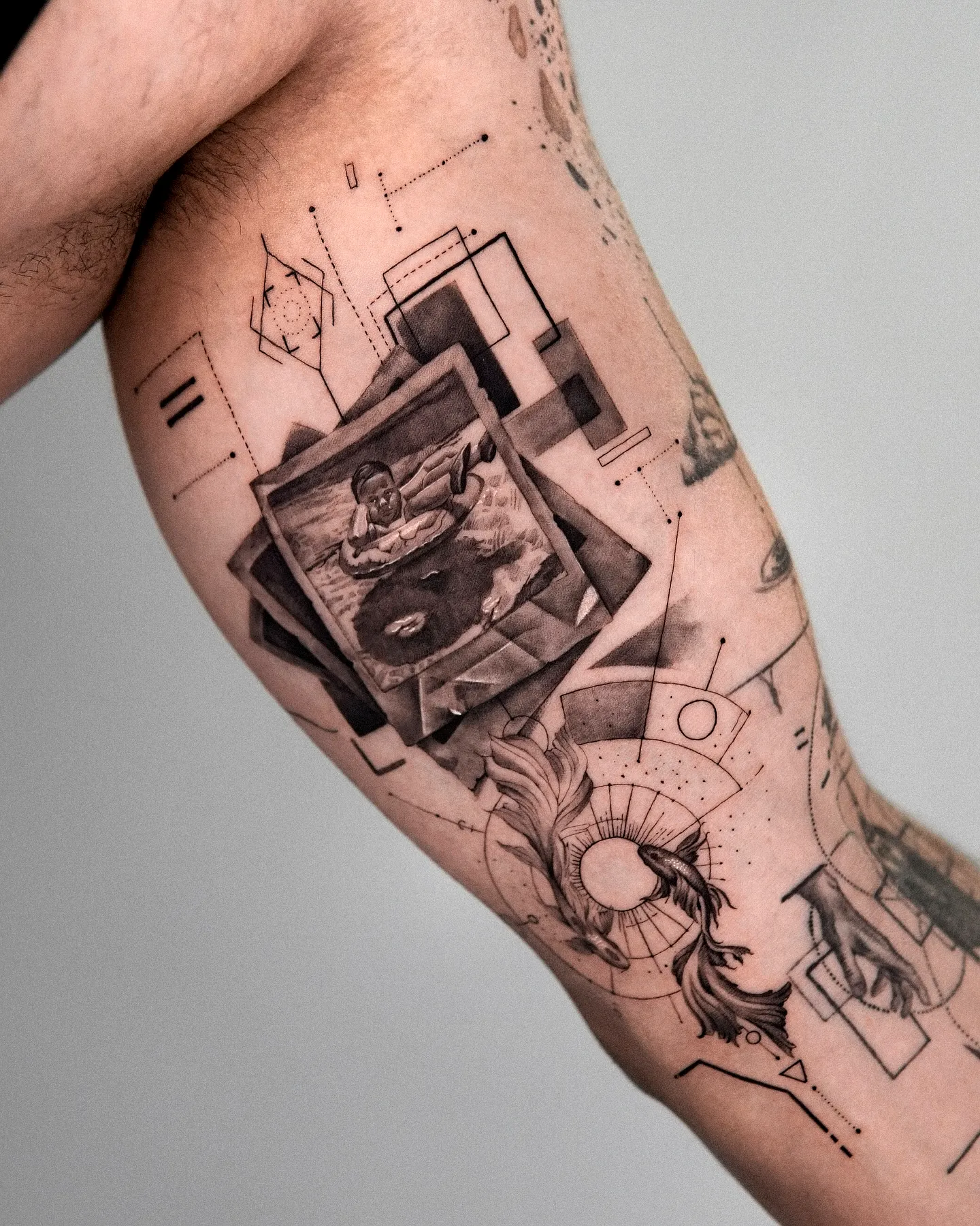 Geometric Water Figure Arm Tattoo