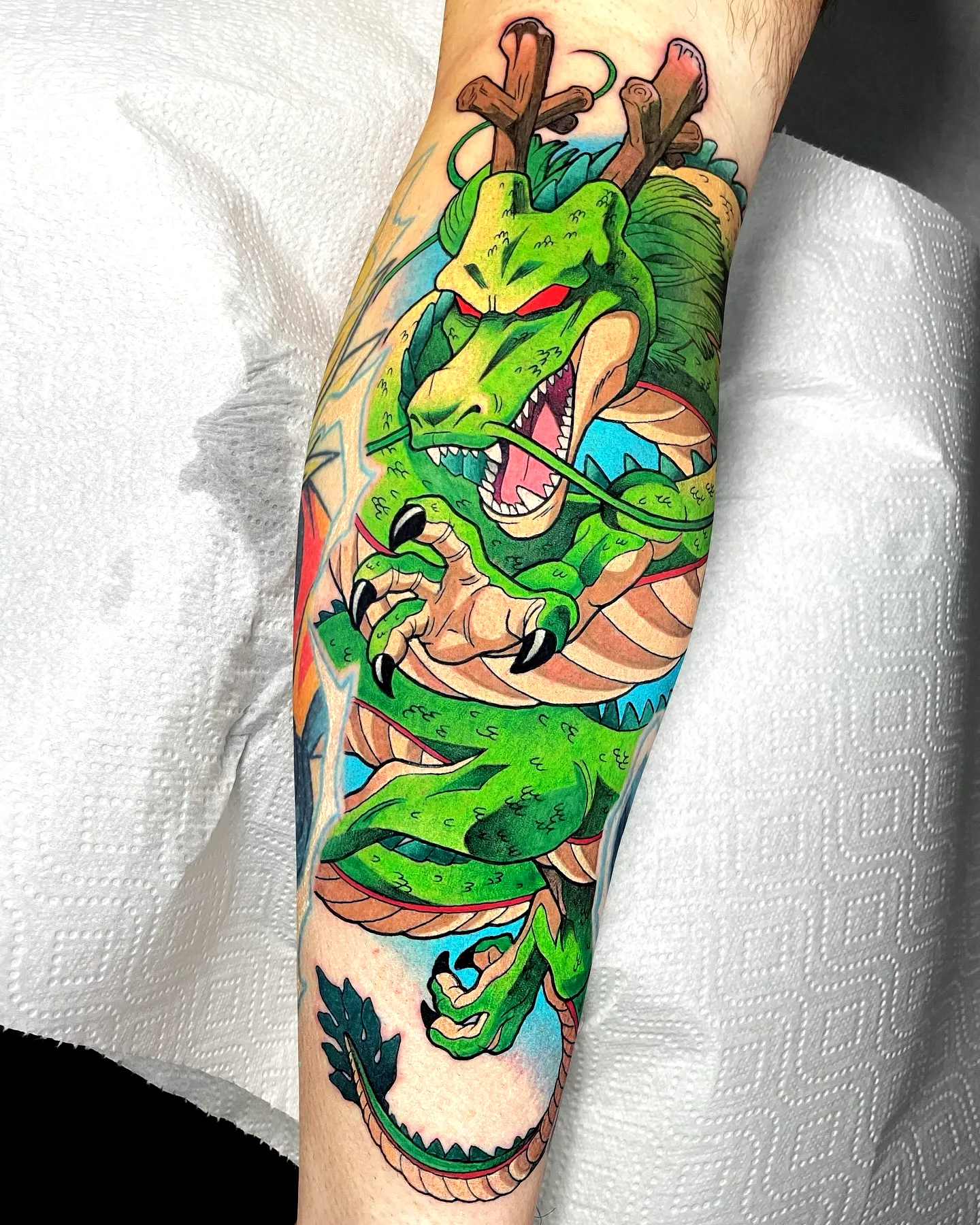 Green Dragon Forearm Tattoo with Waves