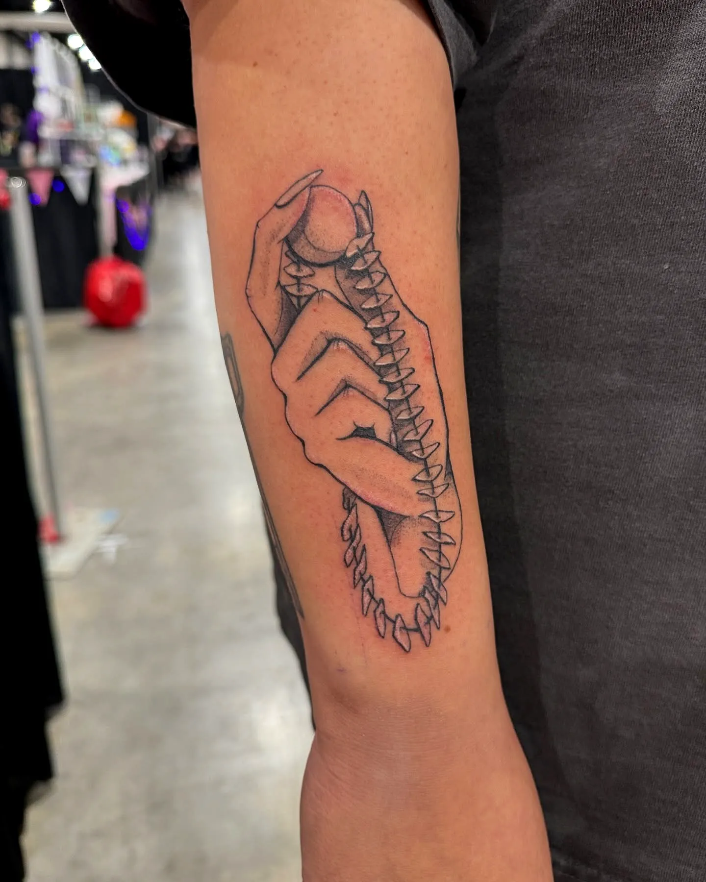 Hand Grasping Ball Spine Tattoo