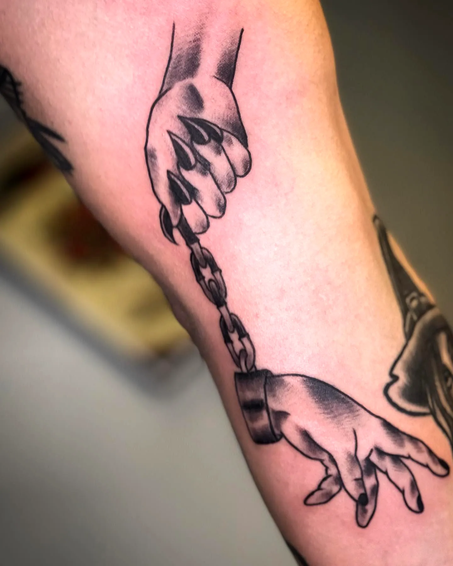 Hands with Shackle Tattoo on Arm
