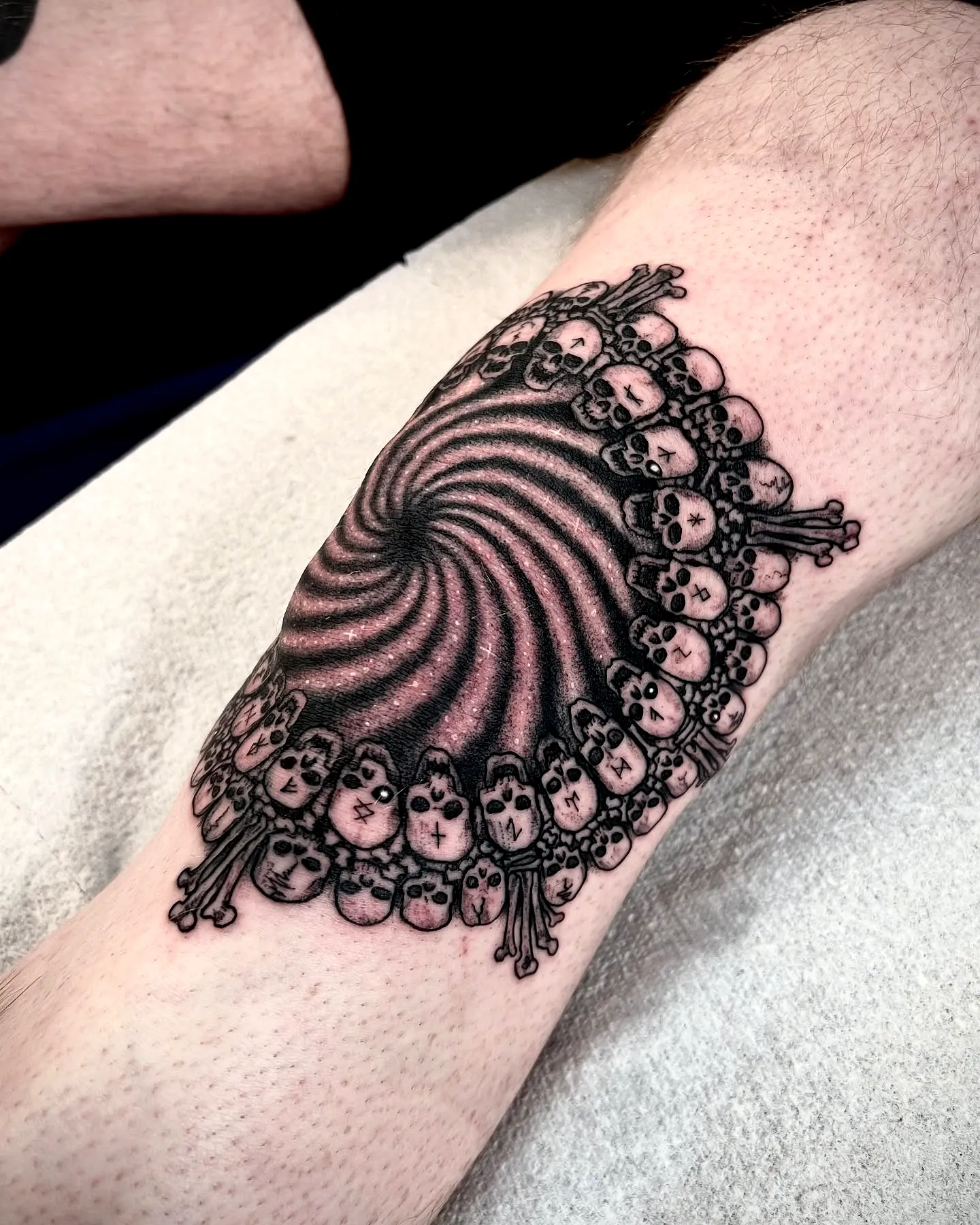 Hypnotic Skull Spiral Elbow Tattoo