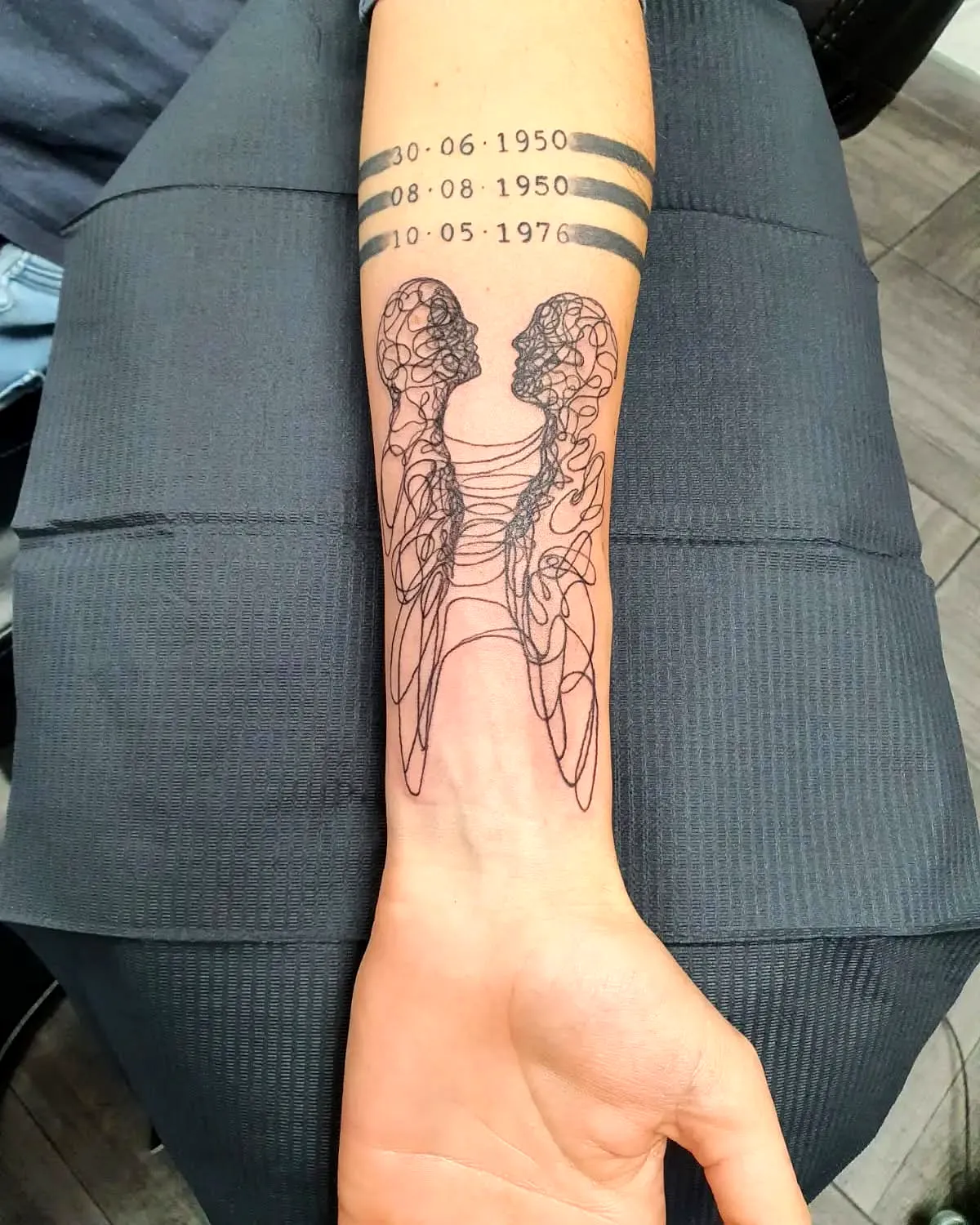 Interconnected Figures Forearm Tattoo