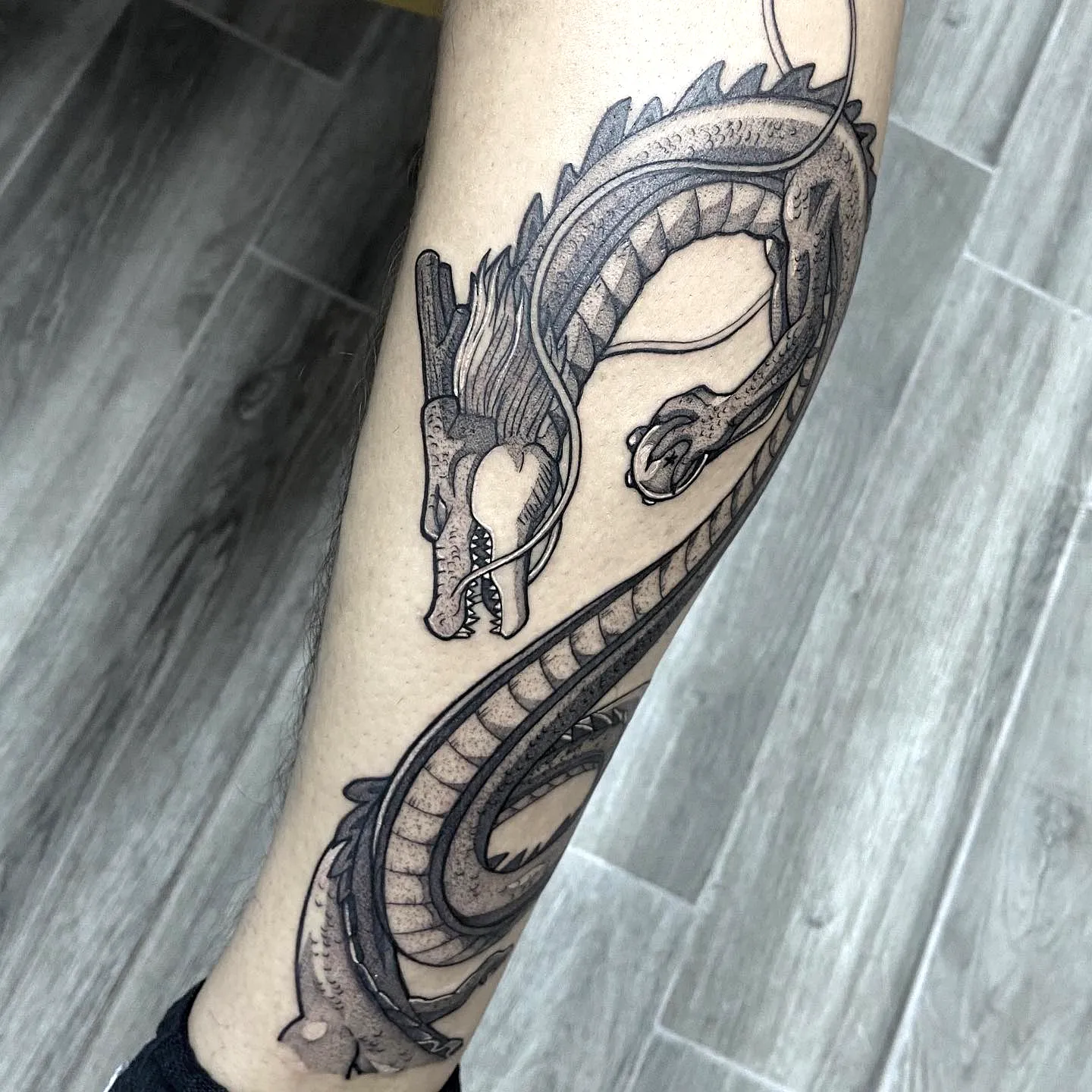 Intricate Black Dragon Forearm Tattoo
