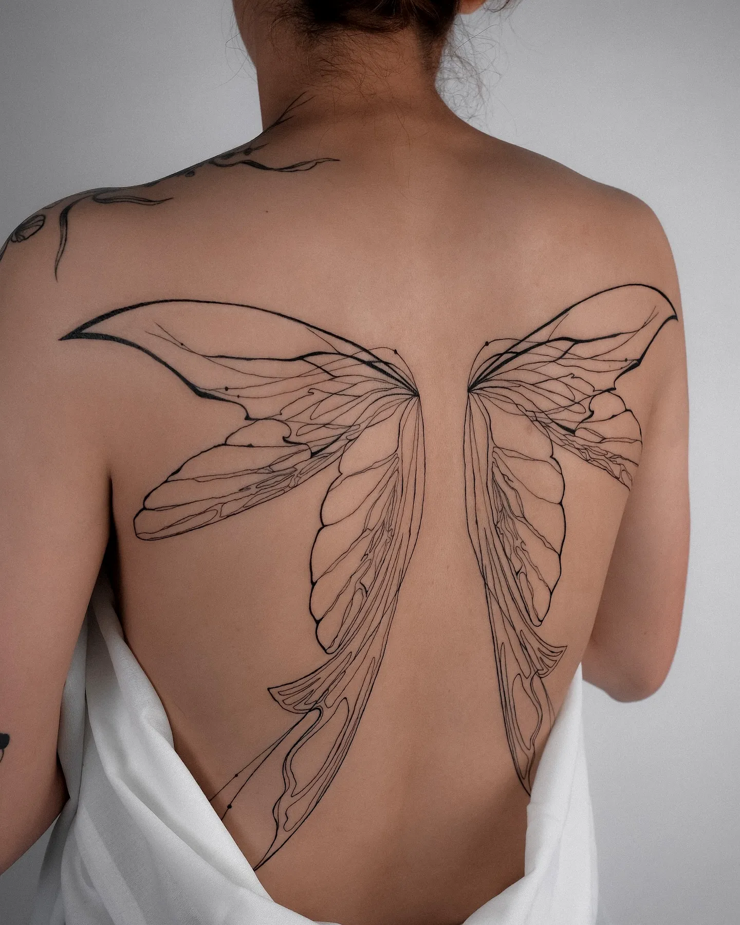 Intricate Butterfly Wings Upper Back Tattoo