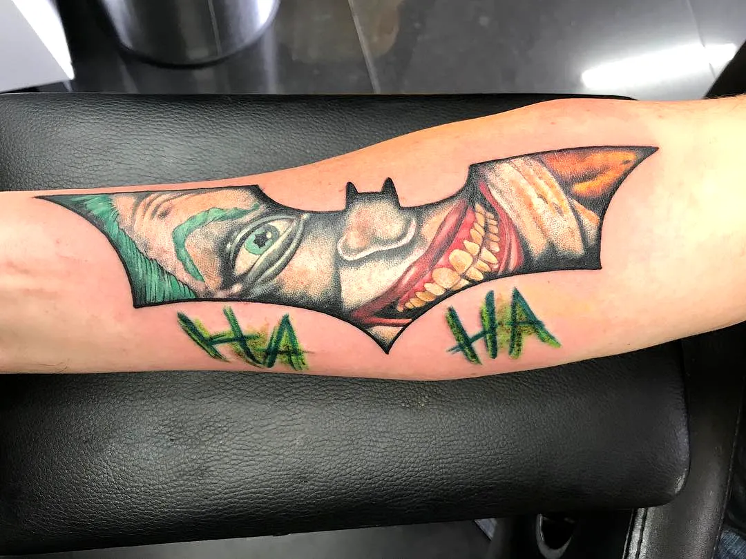Joker Face Bat Outline Arm Tattoo
