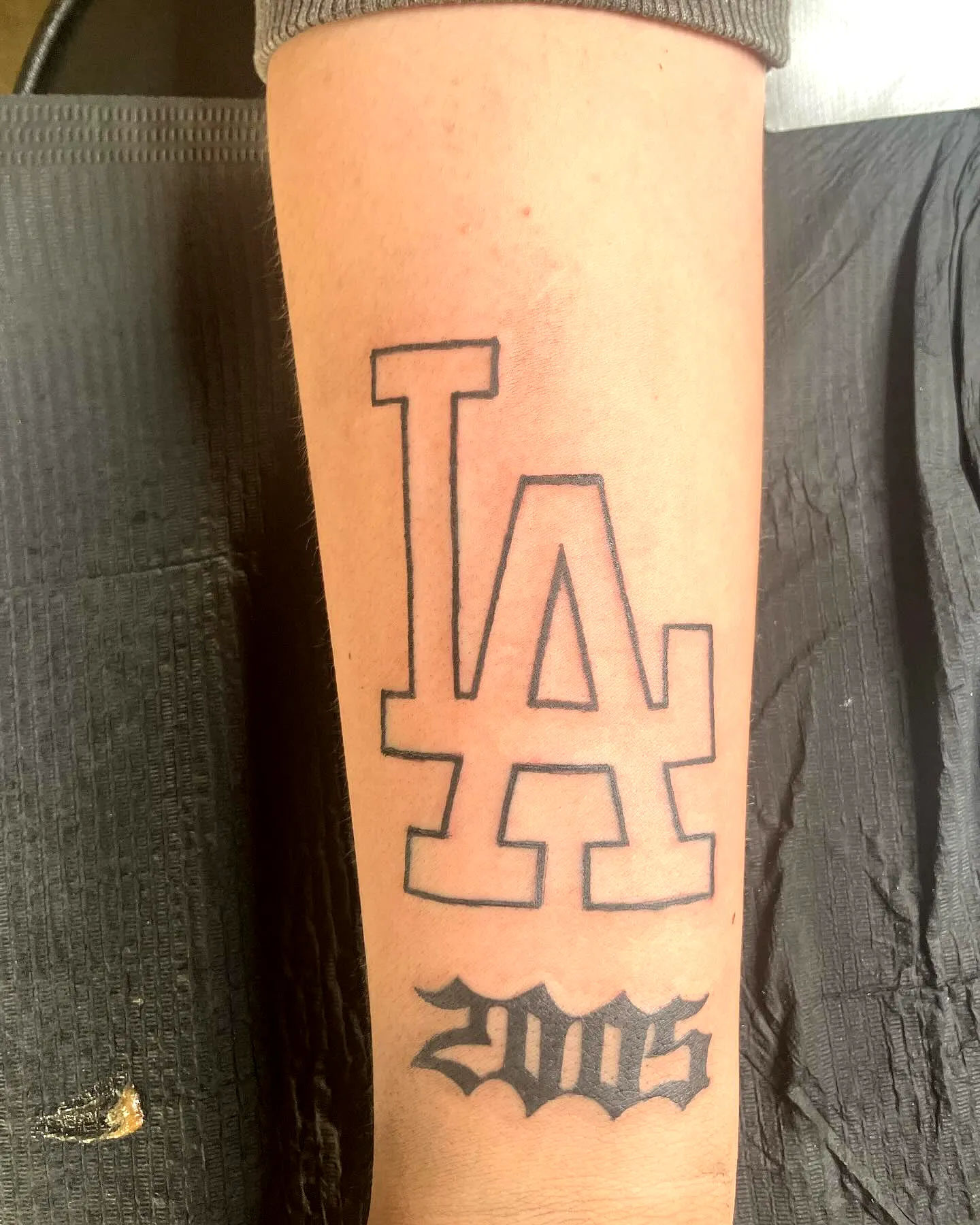 LA Forearm Tattoo in Black Ink