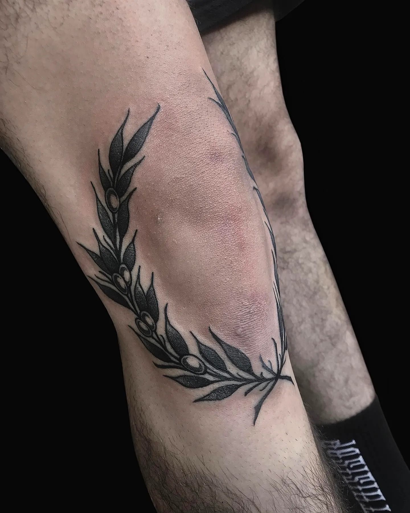 Laurel Wreath Knee Tattoo in Black Ink