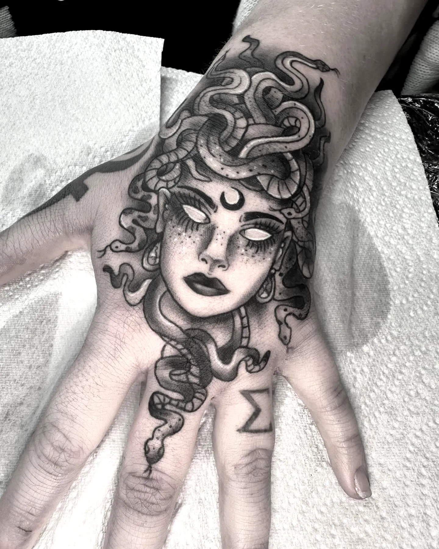 Medusa Hand Tattoo with Greek Sigma Symbol