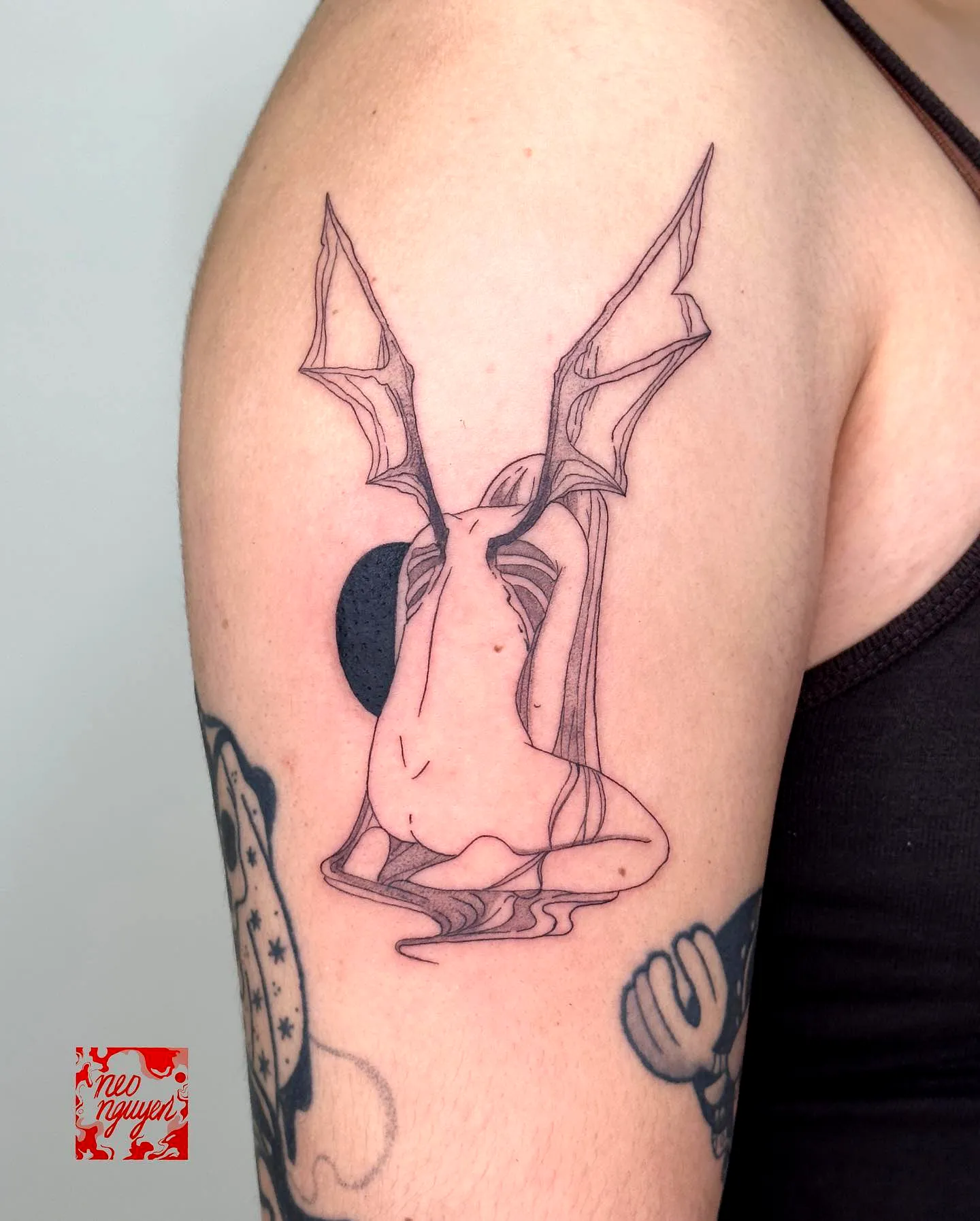 Minimalist Bat Wings Arm Tattoo