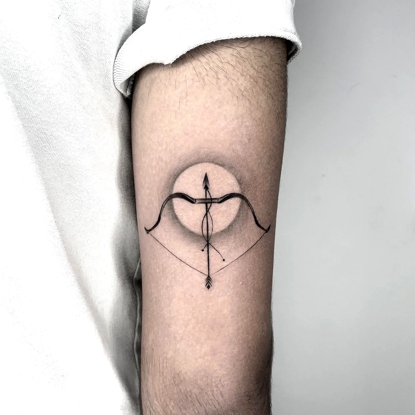 Minimalist Bow and Arrow Forearm Tattoo