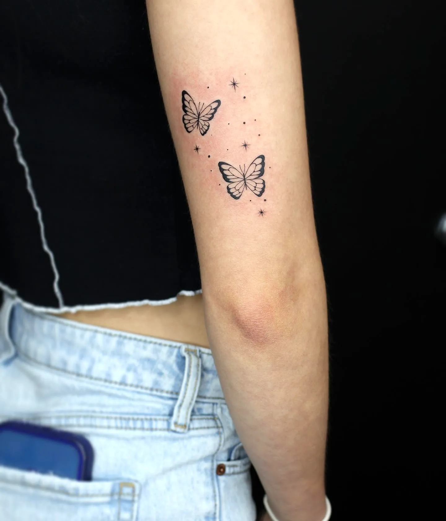 Minimalist Butterfly Upper Arm Tattoo
