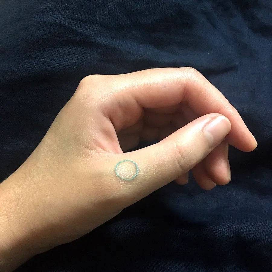 Minimalist Circle Thumb Tattoo