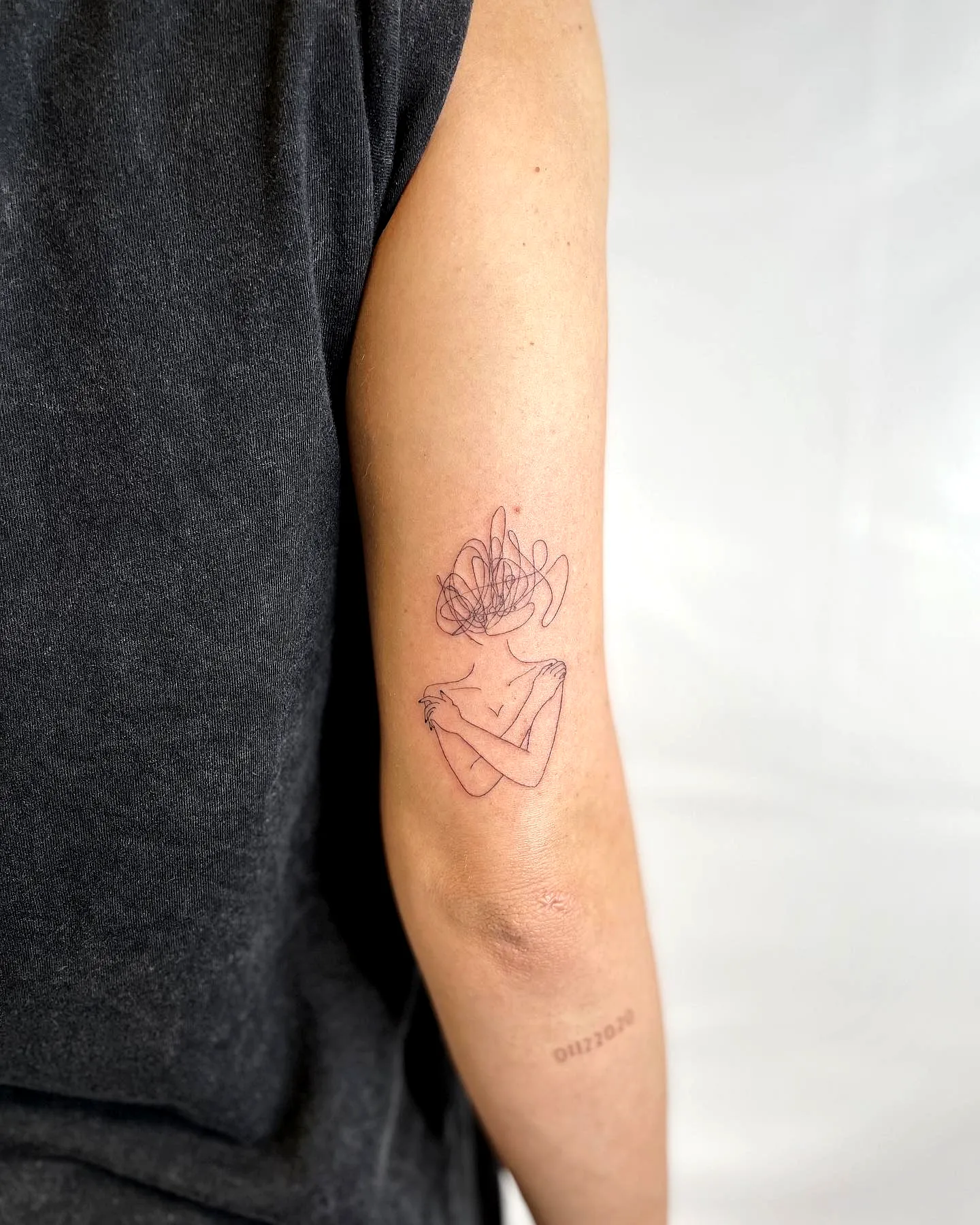 Minimalist Figure Arm Tattoo with Floral Element