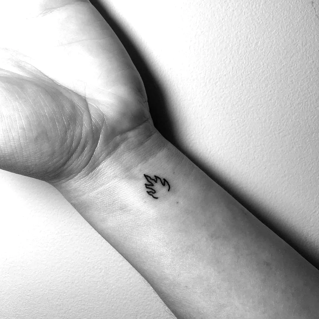 Minimalist Flame Inner Wrist Tattoo