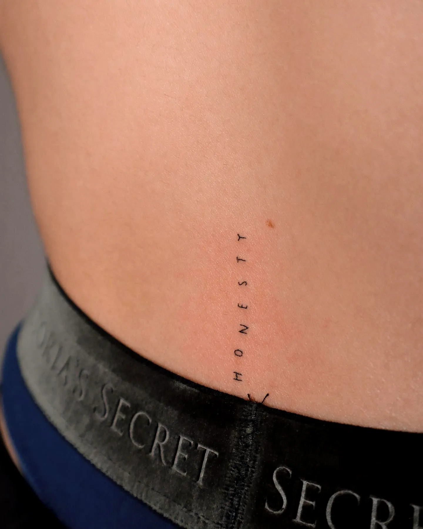 Minimalist Honesty Lower Back Tattoo